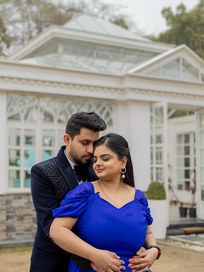 A close-up of the couple, showing her elegant makeup and hairstyle. The look is sophisticated and perfect for a formal pre-wedding shoot.