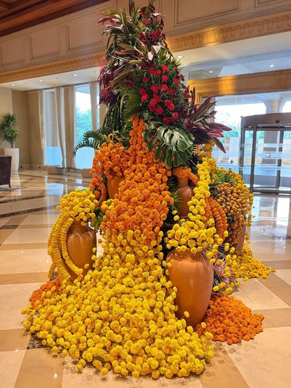 The cascading marigolds in this view create a waterfall-like effect. The combination of traditional flowers with a modern, artistic arrangement style is a signature of my work.