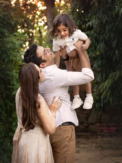 Golden hour, pure joy, and a father lifting his son into the air. This is the magic of candid family photography, where we freeze a perfect, unscripted memory.