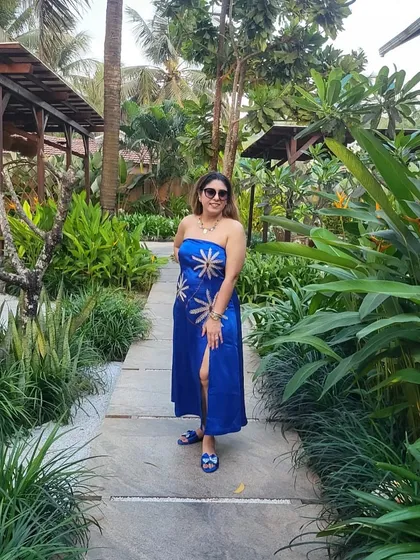 Vacation mode on. This client is wearing a custom blue strapless dress with a thigh-high slit, perfect for a beach holiday.