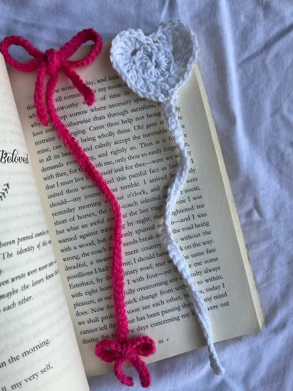 A closer look at my bow and heart bookmark designs. These are handmade with soft yarn and are thin enough to sit comfortably between the pages of your favorite book without damaging the spine.