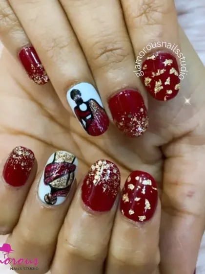 This festive set is perfect for a celebration, featuring rich red nails with gold foil flakes and accent nails with hand-painted art of a woman in a traditional dress.