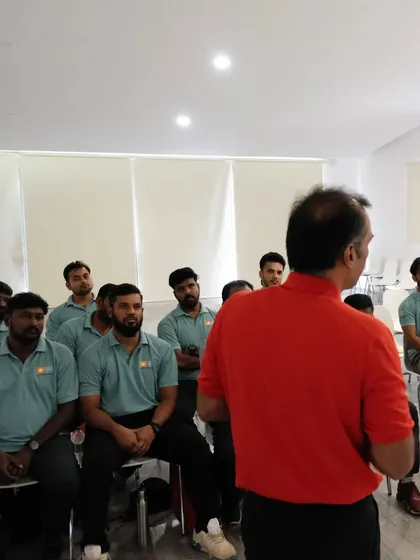 Listening intently during a lecture at the development program. Gaining knowledge from esteemed professionals is key to my growth as a coach.