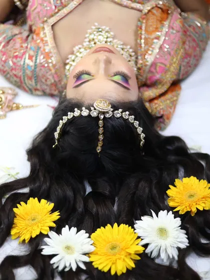 Another creative angle for a portfolio shoot. This upside-down shot draws attention to the intricate eye makeup and the floral hair arrangement.