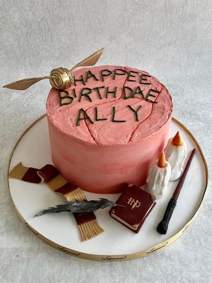 A cake inspired by Hagrid's "Happee Birthdae" cake for Harry Potter. A fun and rustic design for a true fan.