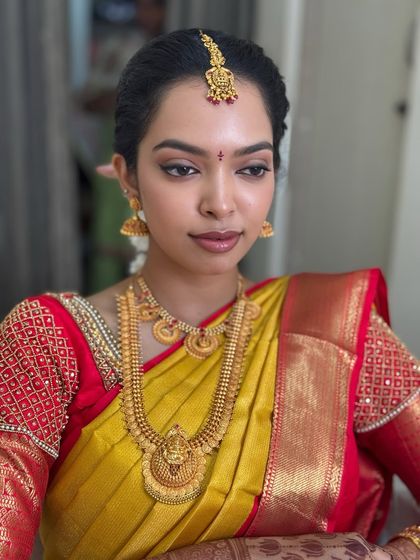 A close-up portrait of Dr. Sushmita. This shot reveals the fine details of her makeup, from the crisp eyeliner to the perfectly matched foundation, creating a look of effortless grace.