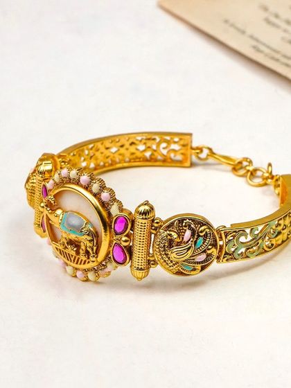 This photo showcases an ornate traditional bracelet with detailed enamel work. The clean, bright styling ensures that the focus is entirely on the product's craftsmanship.