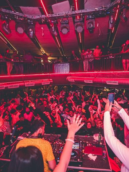 A view from my perspective at the DJ booth, looking out at a sea of people with their phones up, capturing the moment. This is the modern concert experience.