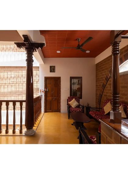 Another view of the upper-level seating area, highlighting the rich texture of the antique pillars against the exposed brick walls and filler slab ceiling.