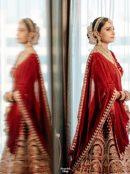 A reflection of elegance. This bridal portrait captures the bride's profile and her reflection in the glass, creating a sense of depth and timeless beauty.