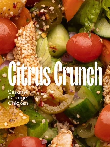 A close-up of the citrus crunch in my chicken salad, showing the vibrant mix of cherry tomatoes, cucumbers, sesame seeds, and jalapeños.
