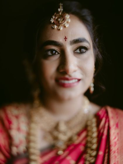 A warm, close-up portrait of a beautiful bride. The soft focus and her gentle smile make this a very personal and endearing shot.