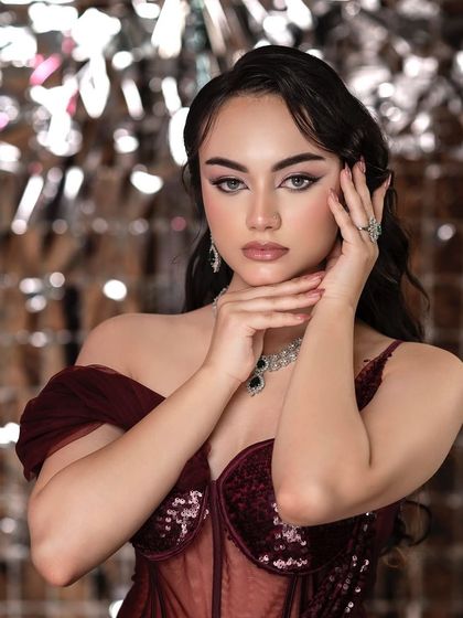 A glamorous look with a sparkling, reflective backdrop. This setup is perfect for party wear or high-fashion shoots, adding a sense of energy and celebration to the image.