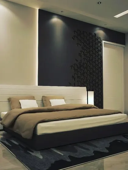 A minimalist bedroom concept focusing on lighting and subtle textures. An accent wall with a 3D pattern is highlighted by spotlights, creating a play of light and shadow that serves as the room's main decorative feature.