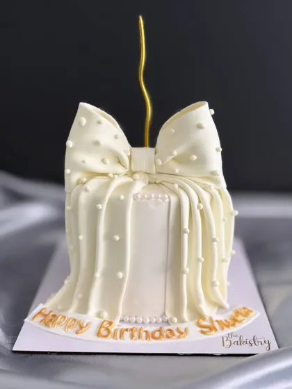 This cake is a testament to simple elegance. I crafted this stunning all-white birthday cake featuring a delicate, hand-draped bow and pearl-like details, showing that sometimes, the most understated designs make the biggest statement.