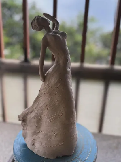 I find so much joy in sculpting the human form. This clay sculpture of a dancing woman was about capturing a feeling of freedom and grace. It’s an unglazed stoneware piece that celebrates movement and form.