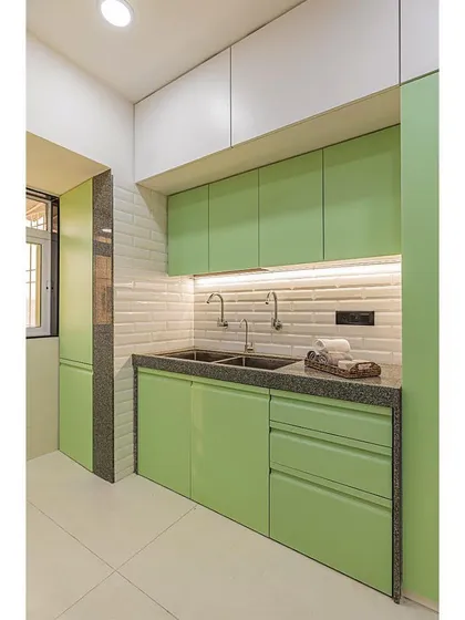 This view highlights the dual-sink area, a practical feature for a busy family kitchen. The white overhead cabinets keep the space feeling light and airy.