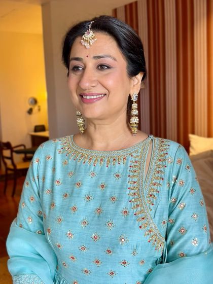 A close up of this mother of the groom's radiant look. The makeup is soft and flattering, designed to look beautiful both in person and in photographs.