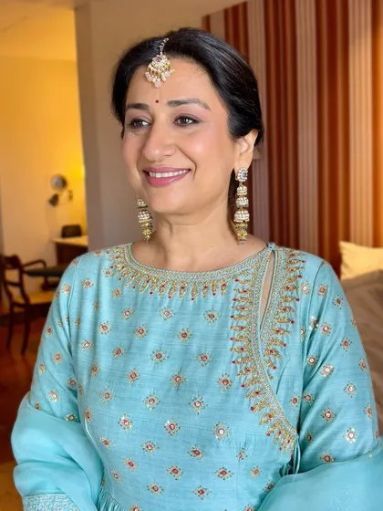 A close up of this mother of the groom's radiant look. The makeup is soft and flattering, designed to look beautiful both in person and in photographs.
