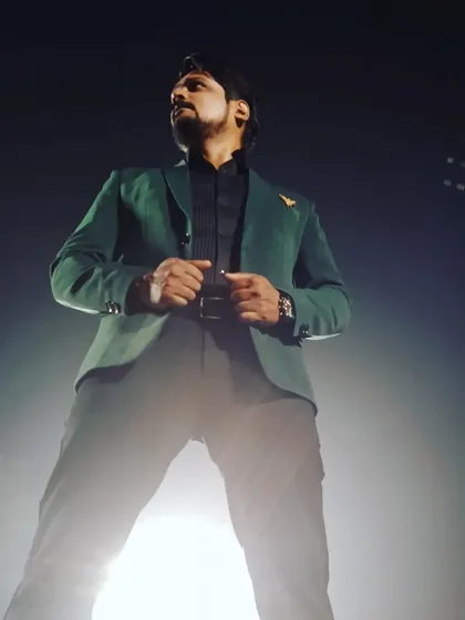 Another powerful pose in a dark green blazer before a show. The spotlight is my friend, and I always dress for it.