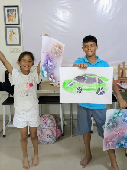 Look at these proud smiles from our Saturday junior batch! Students are showing off their unique creations, including a cool green sports car and a beautifully drawn character.