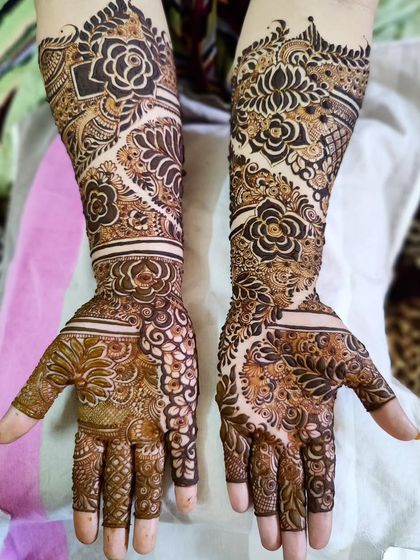 A beautiful example of a semi-filled bridal design. The patterns are intricate but leave some skin showing, creating a delicate yet full look.