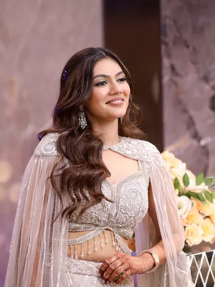 A happy and radiant Sangeet bride. Her makeup is a perfect balance of glam and natural, with a focus on enhancing her beautiful smile and sparkling eyes.