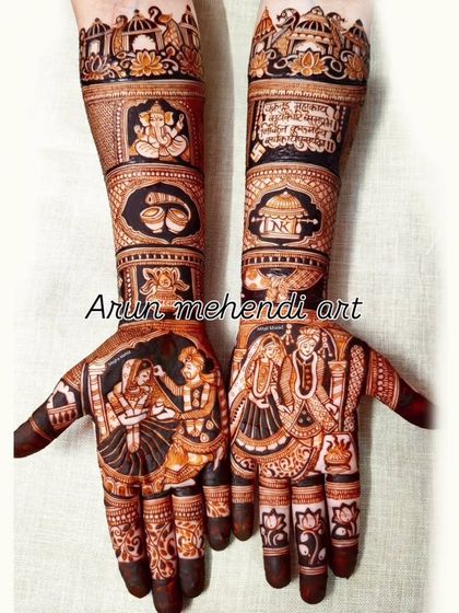 A design filled with wedding rituals, from the varmala ceremony on the palms to Ganesha and other auspicious symbols on the arms.