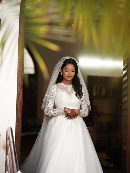 A full-length portrait of the bride in her stunning white lace gown. I styled her hair in soft curls and kept her makeup classic and timeless to match the elegance of her dress.