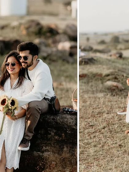 A bright and sunny picnic-themed pre-wedding shoot. The couple, dressed in white and holding sunflowers, looks happy and relaxed in this beautiful outdoor setting.
