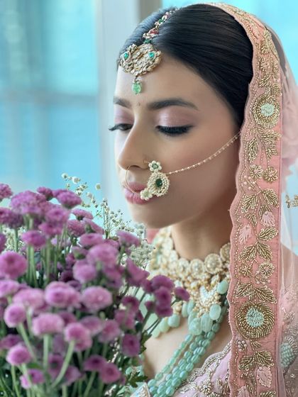 Wrapped in shades of pink and love. This dreamy bridal look features a soft glow and romantic hues, with a focus on ethereal eye makeup using pink and lilac tones.