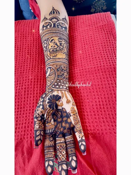 A detailed portrait of the groom on the palm, surrounded by intricate patterns and leading up to a band of royal elephants.