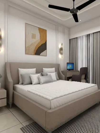 An elegant bedroom featuring a winged headboard, stylish wall sconces, and a dedicated work-from-home corner. The design proves that a bedroom can be both a restful sanctuary and a productive space.