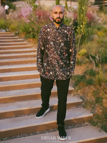 A full-length shot of my floral print outfit for the Greek wedding, with the beautiful scenery behind me.