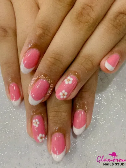 A sweet and classic look, this design features a pink base with a crisp white French tip and delicate 3D floral accents.
