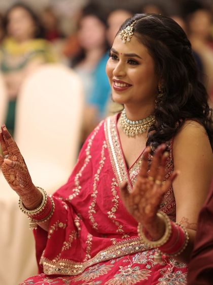 A candid moment of joy during the sangeet. Our long-lasting makeup ensures that our bride looks fresh and radiant even while enjoying the festivities.