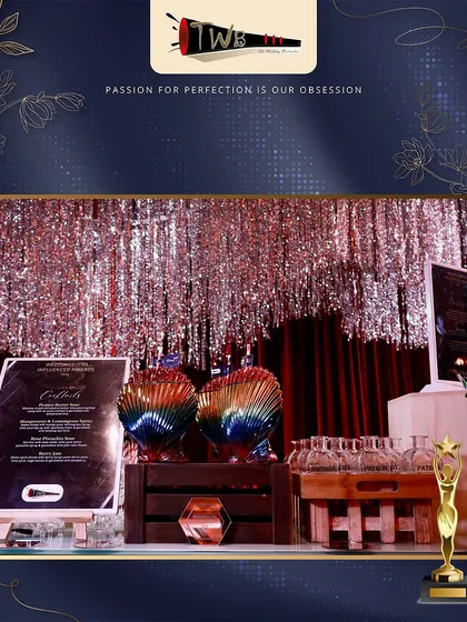 A glamorous bar setup for an awards night, featuring a shimmering silver tinsel backdrop, elegant glassware, and a professionally designed menu.
