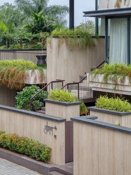 This villa in Indore by Span Architects features a multi-level facade with cascading greenery, creating a series of terraced gardens.