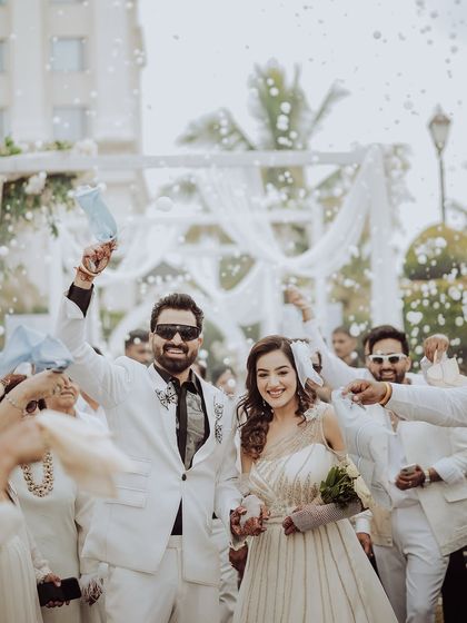 A moment of pure celebration. The couple is showered with bubbles and cheered on by their guests, their happy faces telling the story of a perfect reception party.