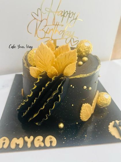 Black and gold never gets old. A luxurious cake with black frosting, gold leaves, and Ferrero Rocher chocolates.