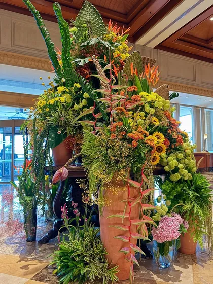 My work often involves transforming large spaces with nature's finest. This grand floral installation for a hotel lobby is a symphony of color and texture, blending sunflowers, heliconias, and diverse greenery to create a breathtaking welcome for every guest.
