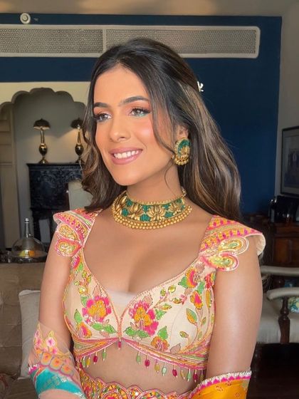 A side profile of the bride, showing how the half-up style and soft waves create a romantic and flattering look.