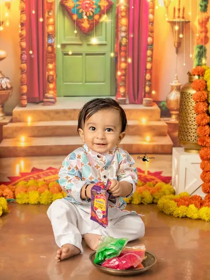 Look at this little sunshine enjoying our special Diwali setup! I love creating these festive mini-sessions, complete with colorful decor and props, to make your celebrations truly unforgettable.