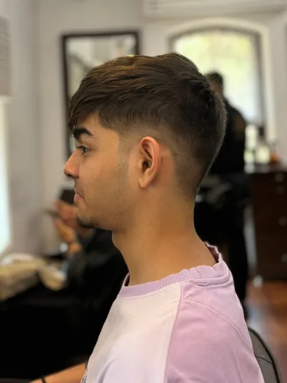 A great men's haircut is all about the details. This client wanted a clean and modern look, so we delivered a sharp skin fade that blends perfectly into a textured top. It's a versatile style that looks effortlessly cool.