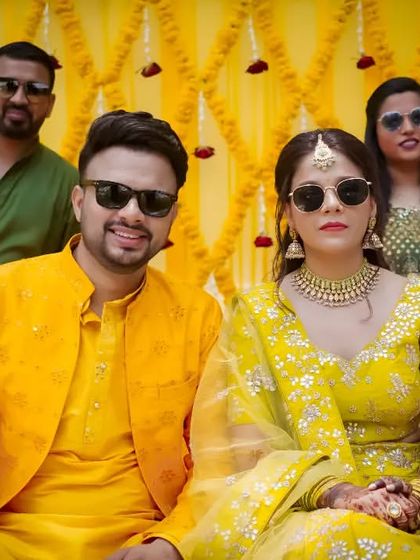 A cool and stylish group photo with the couple and their friends wearing sunglasses during the Haldi ceremony.