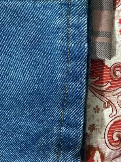 A close-up of the inseam stitching on a pair of jeans, demonstrating the durable construction that ensures your custom clothing is built to last.