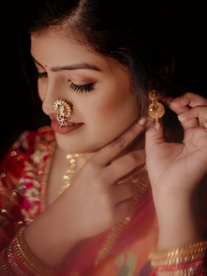 Embracing tradition from head to toe. This close-up shot highlights the intricate 'nath' and the soft, glowing makeup that complements it perfectly.
