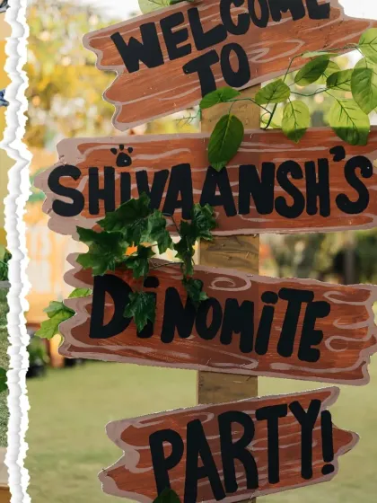 A personalized wooden sign for 'Shivaansh's Dino-mite Party'. We love creating custom details that make the birthday child feel extra special.