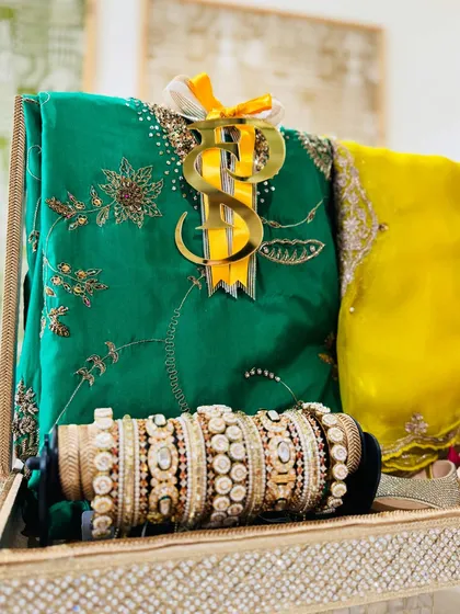 The full view of the green and yellow trousseau tray, showcasing the beautiful contrast of colors and the thoughtful arrangement of each element.