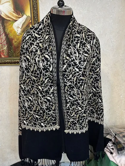 This is an example of the beautiful, authentic Kashmir pashminas I source. The intricate silver embroidery on the black fabric is stunning and feels incredibly soft and luxurious.